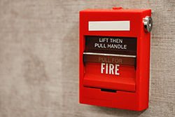 Fire alarm on beige wall