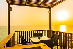 Sunrise view over the ocean from a pergola and deck designed by decking contractor in Brighton Beach