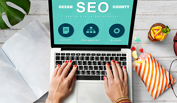 Ocean County SEO on laptop with a teal background